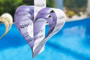 ge9ac2c7ba6b4d86aa8bf2b5d3130df45f3f6b2e5ed4469eb89c02022f60b325e27659e43096364522437fd24e926088680cc268787aa4bd519e8fe0549f3f912_1280-7284253 heart, music, love, paper craft, handmade, summer decor, music sheet, heart shape, romantic, art project, floating heart, poolside decoration, music lover, creative decor, valentine's day, wedding decor, diy craft, musical note, artistic heart, blue background, relaxing vibe, romantic paper art, love ornament, paper sculpture, musical heart